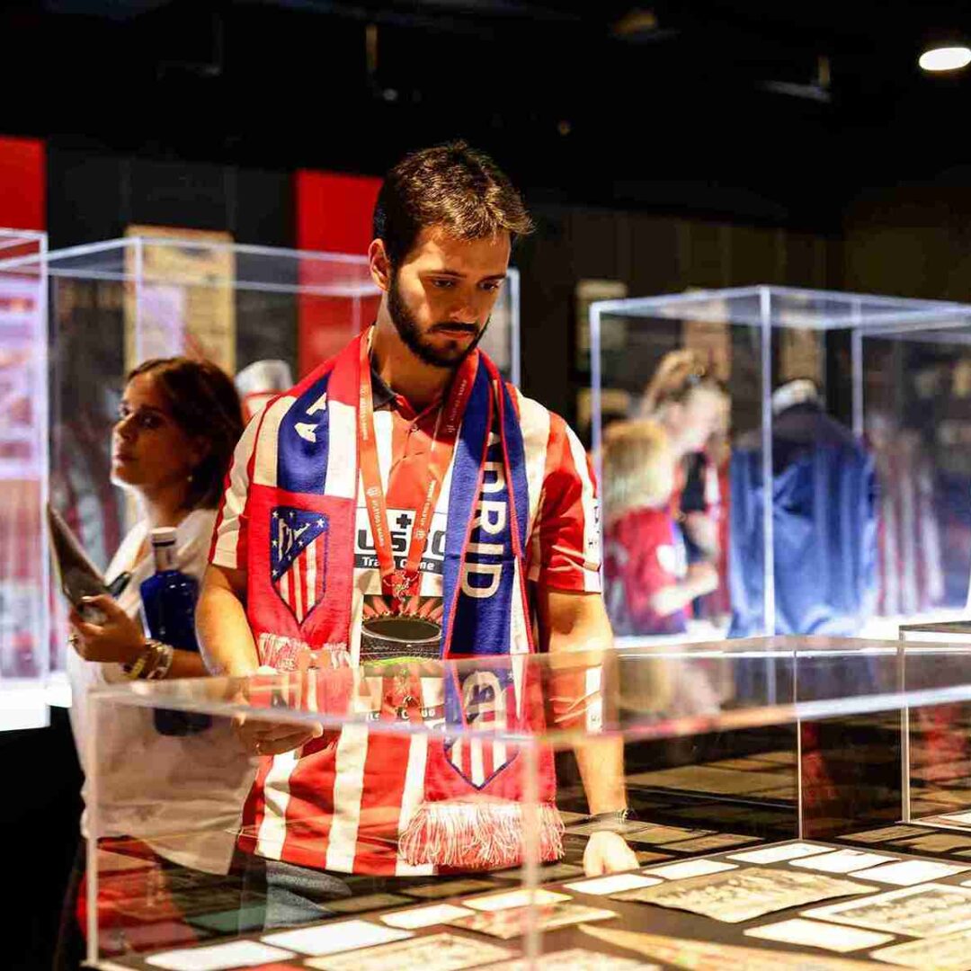 Gente mirando las vitrinas del museo del Atleti